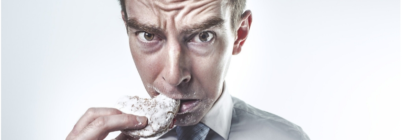 man looking worried eating cookie