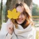 woman with allergies holding autumn leaf