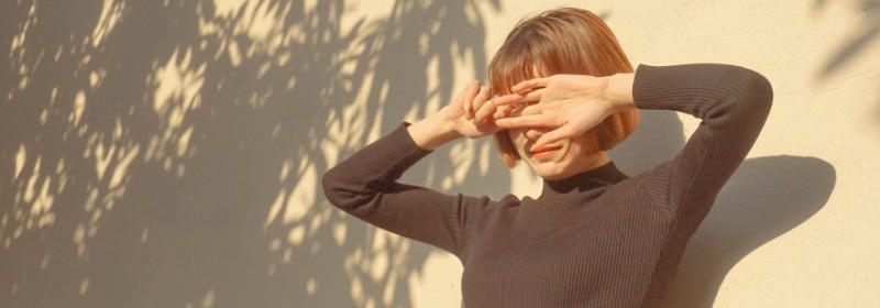woman covering face from sun