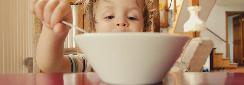 child eating cereal from a bowl