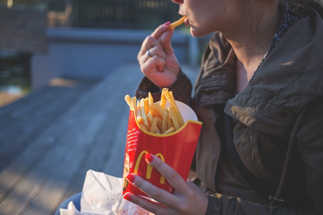 woman eating fast food which often contains MSG